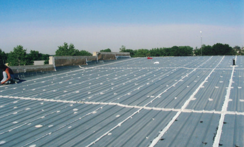 Before photo of the metal roof on top of Freeman Foods in Wellman, IA.