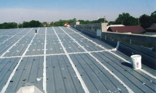 Before photo showing the length of the metal roof needing work.