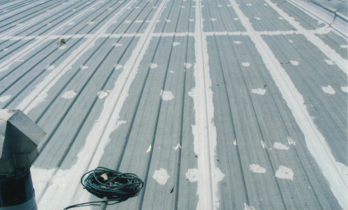 Close-up before shot of the roof after being pressure washed.
