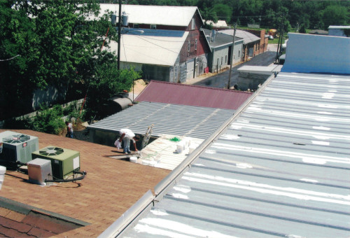 Photo from the upper roof, overlooking the lower roof and street below.