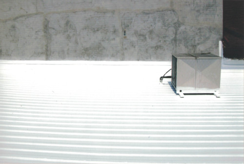 After photo of the bright sheen of the freshly coated metal roof.